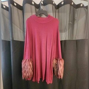 Fabulously feathered! This lightweight sweater is an eye catcher.